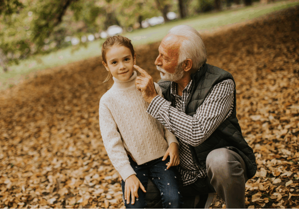 An older grandparent with his granddaughter.